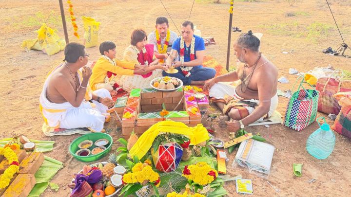 The pooja under way, with offerings laid out on the ground
